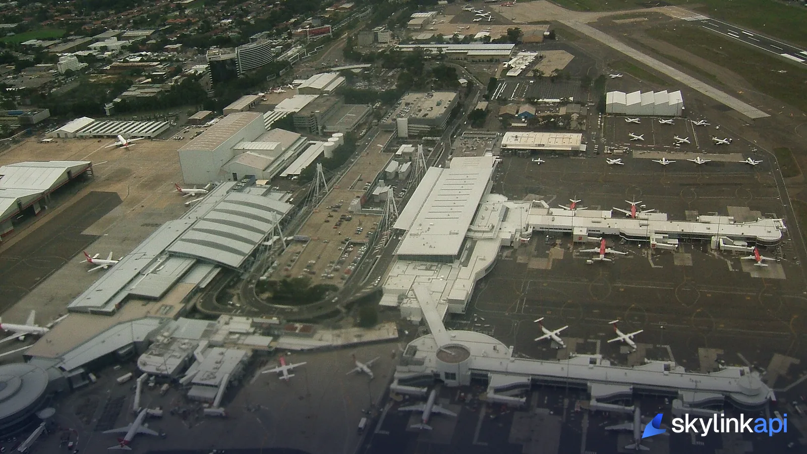 Aircraft parked at an airport's terminal gates, seen from above