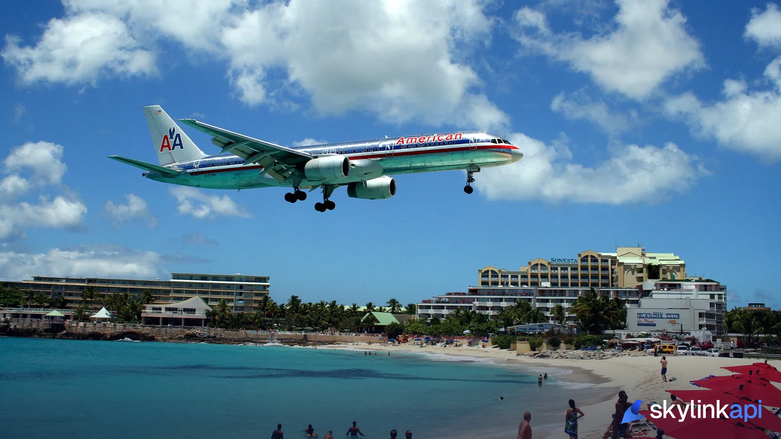 An American Airlines Boeing 757 on final approach, low over the beach at St Maarten