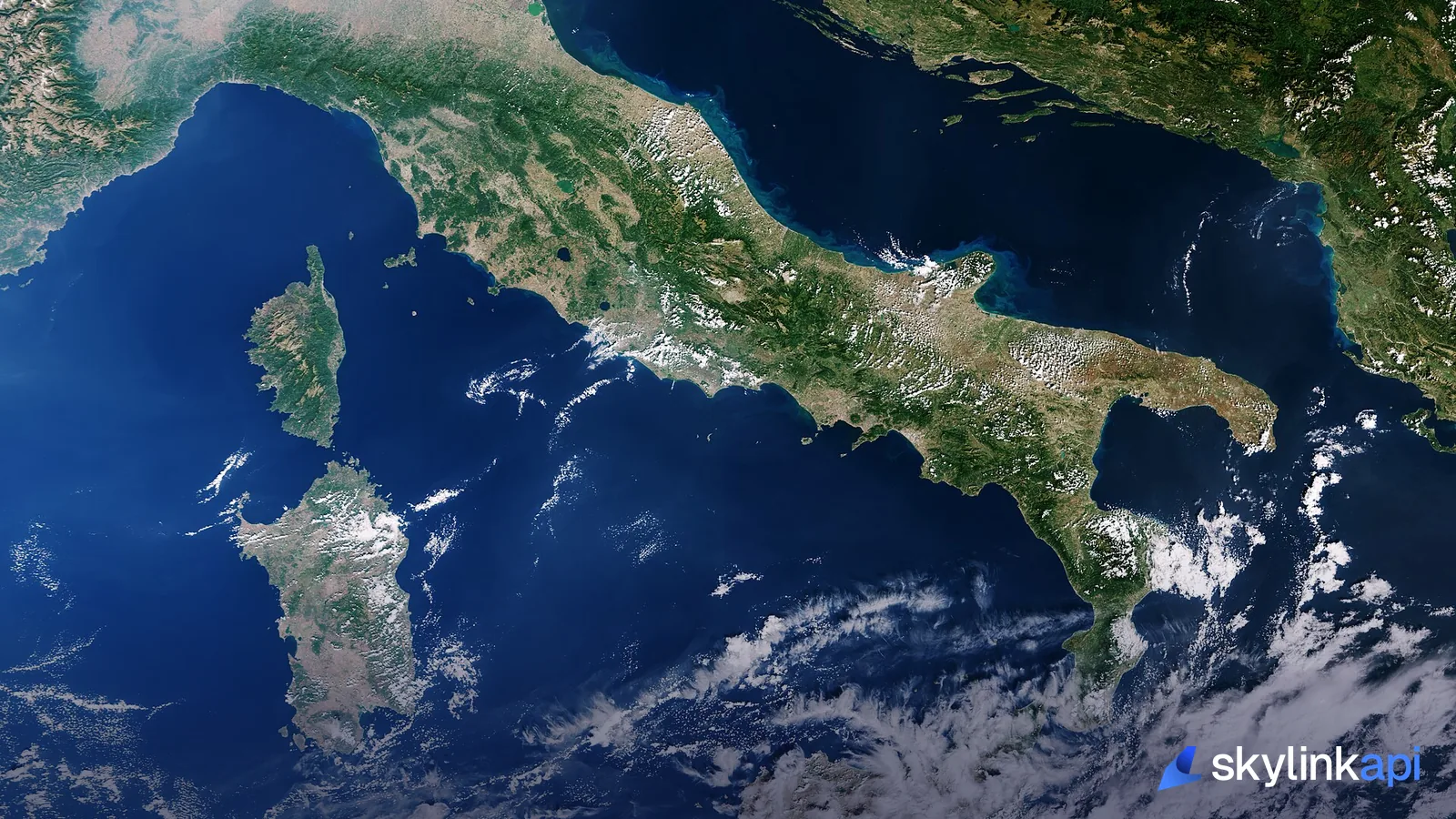 A satellite view of Italy and the Mediterranean with patches of cloud