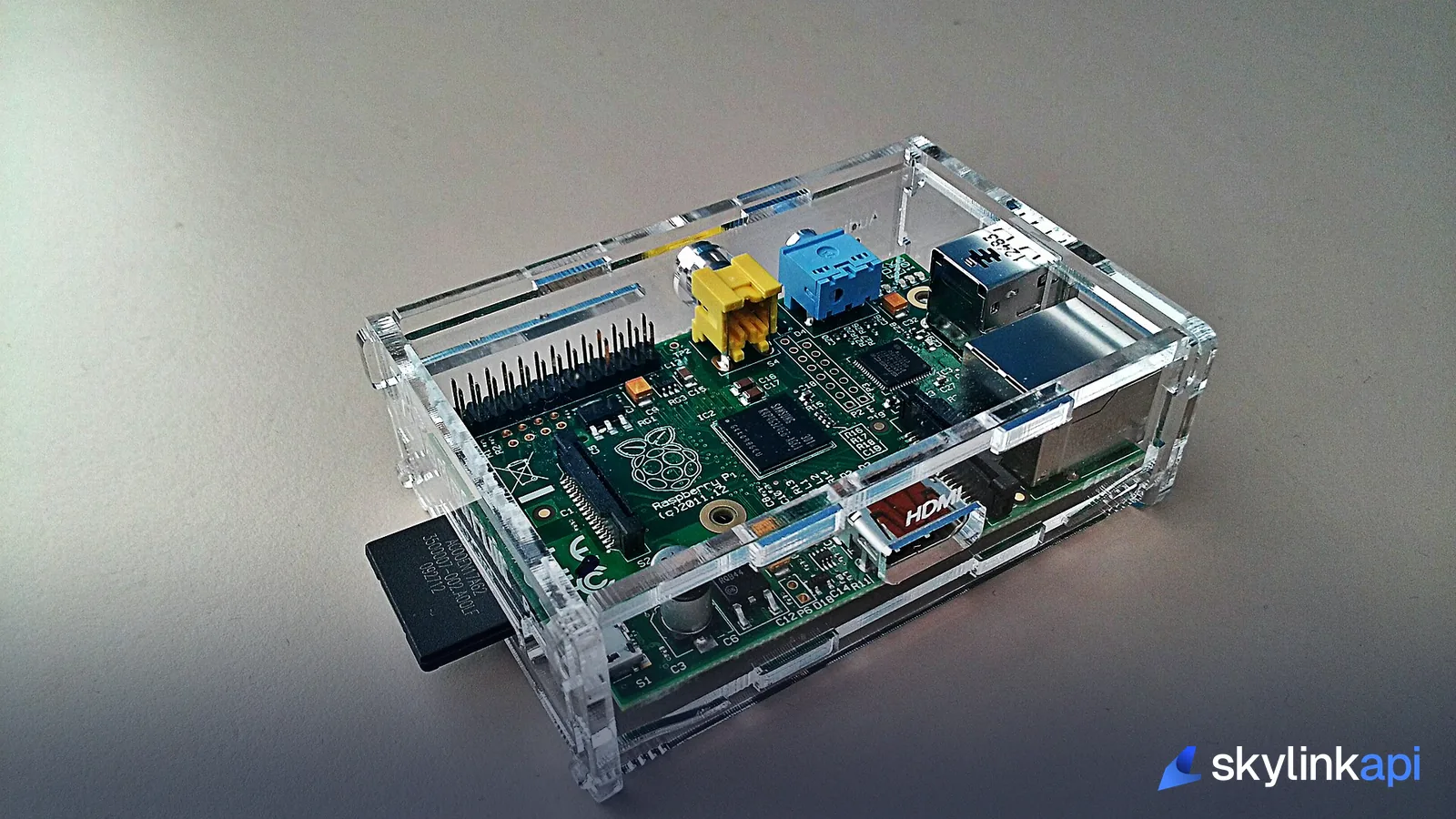 A Raspberry Pi single-board computer in a protective case, the compute behind the departure board