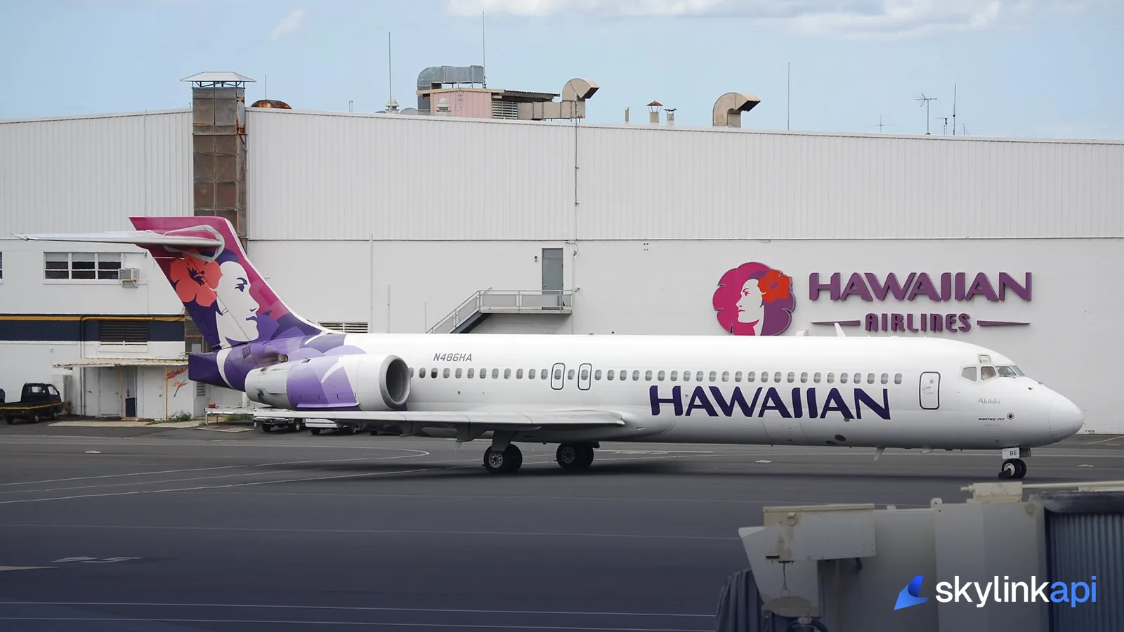 An airliner at its gate at a busy airport terminal