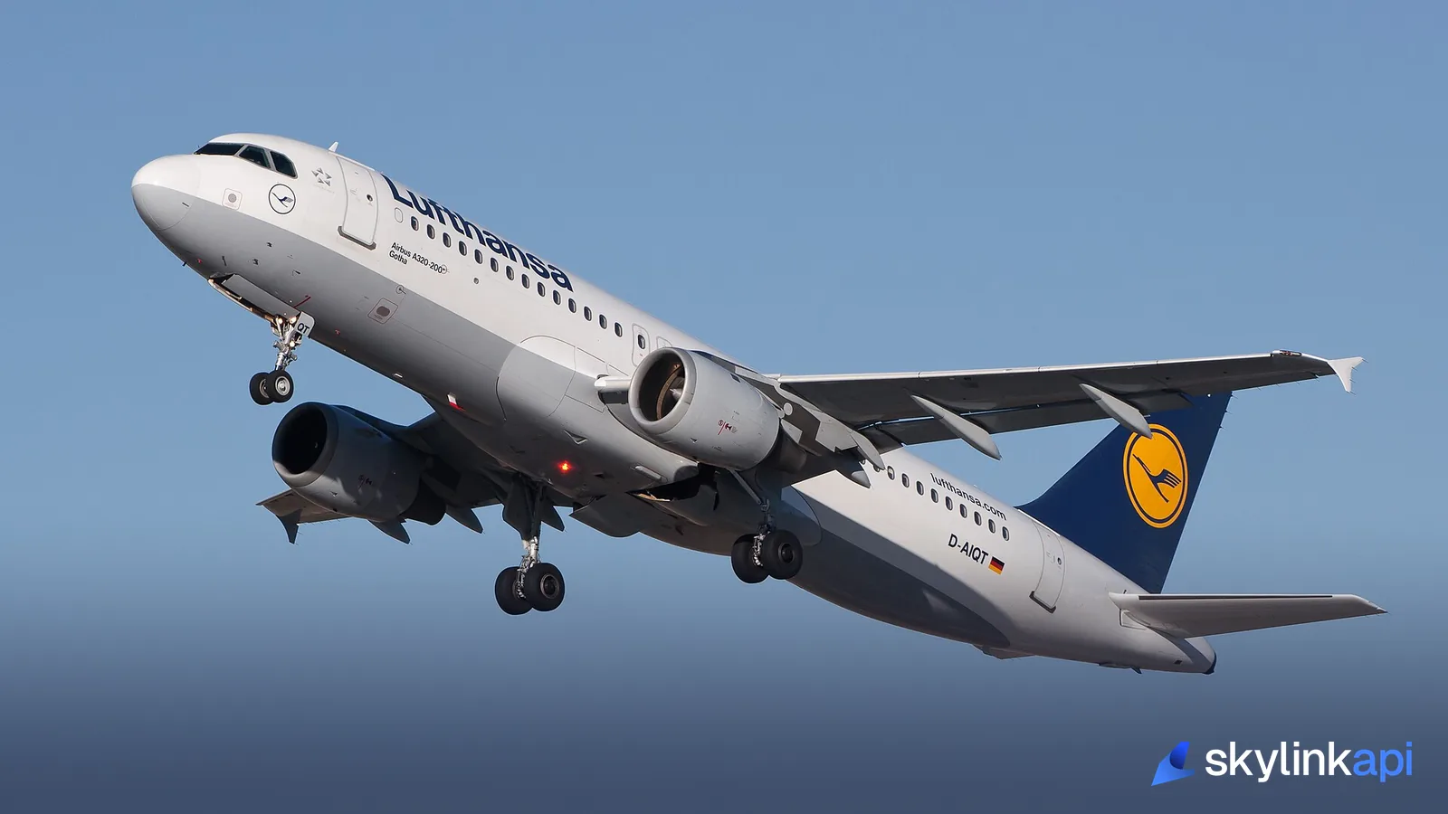 A Lufthansa Airbus A320 climbing away from the runway just after takeoff, its landing gear retracting
