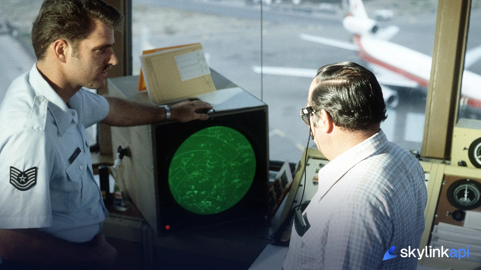 Air traffic controllers working at a radar scope
