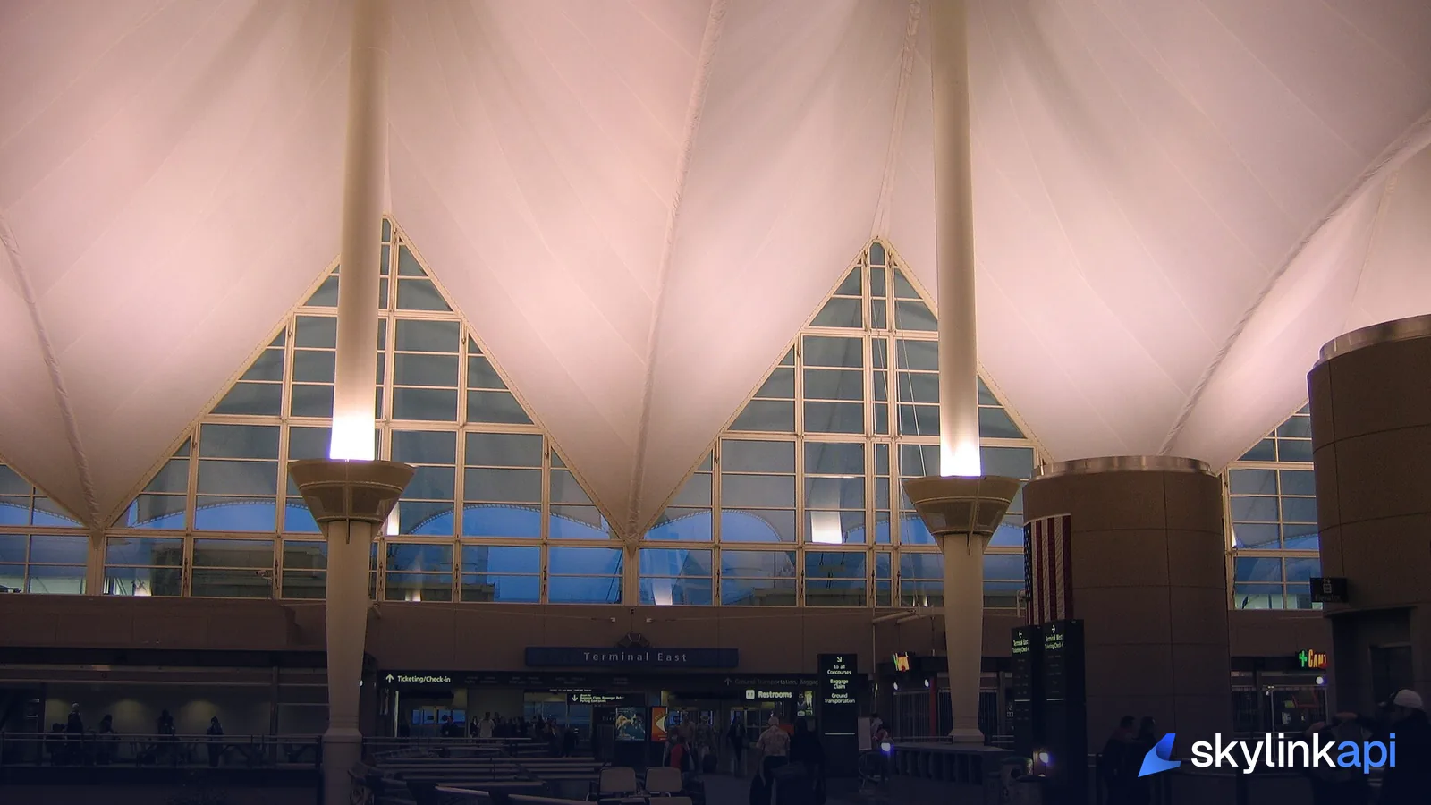 The tented roof of Denver International's main terminal, lit at dusk