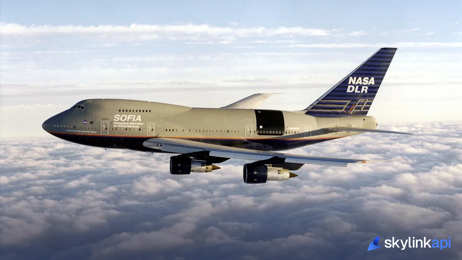A jumbo jet cruising high above a deck of cloud