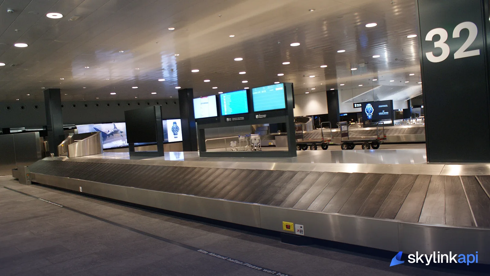 An airport baggage-claim carousel, where every bag tag carries the airport's three-letter IATA code