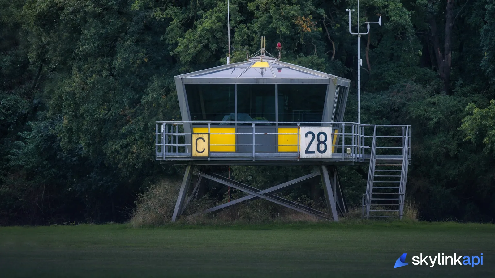 Airport control tower at dusk where air traffic control issues and monitors active NOTAMs