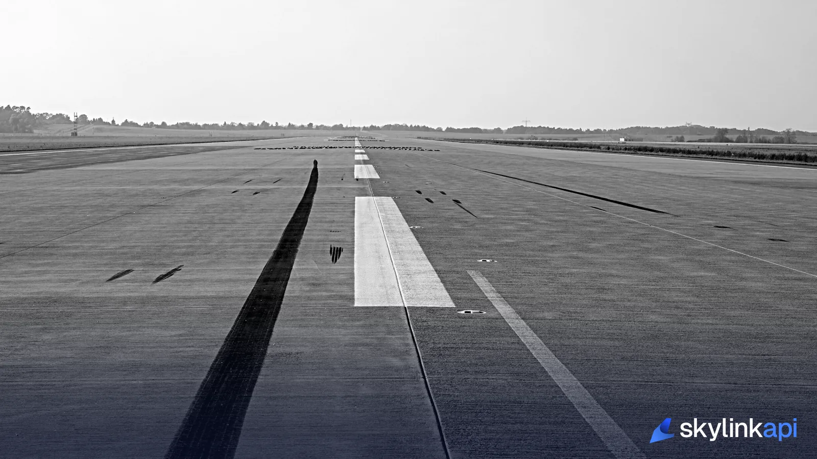 Airport control tower marked C/28 surrounded by trees, the kind of facility NOTAMs are issued from