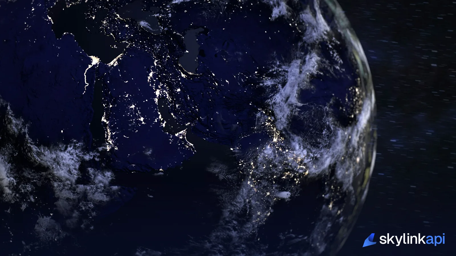 View of Earth from space at night showing illuminated regions, representing global flight-tracking coverage