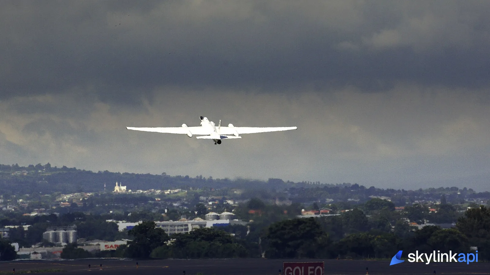 A high-altitude aircraft flying above heavy weather, the kind that forces a hold at a destination