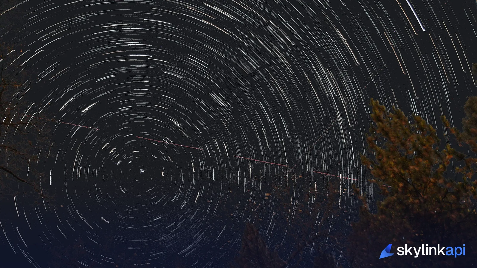 Circular star trails around the north star in a long-exposure night sky, Earth's rotation made visible